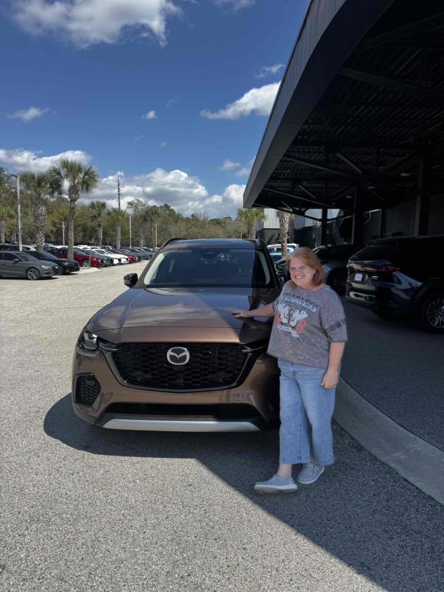 Happy Deal Drvn client at delivery with her new Mazda CX-70 after saving over $6,000